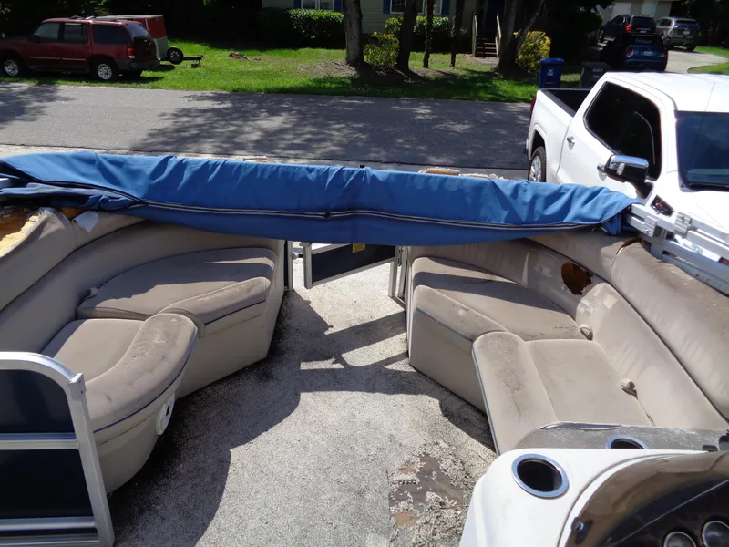 Slide: The Image of 2013 South Bay 422 FCR pontoon boat interior with beige seating and blue cover. - 4