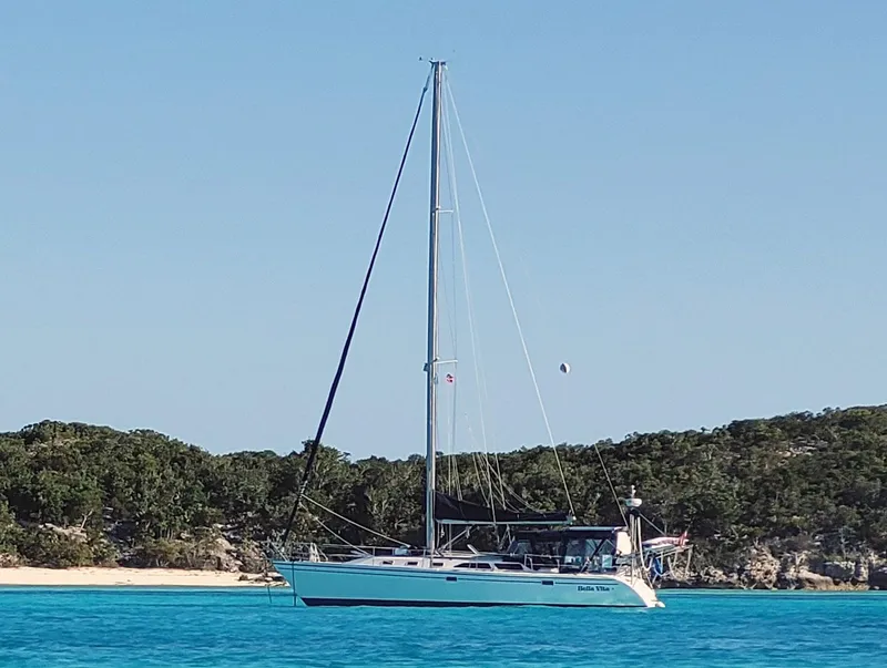 Slide: The Image of Sailboat Catalina 42 MkII 1999 anchored in clear blue water near a sandy beach. - 1