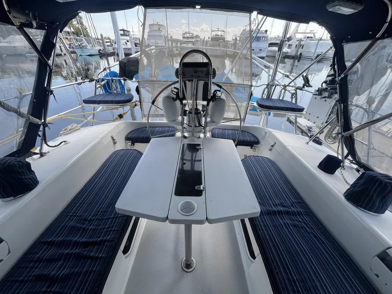 Slide: The Image of Cockpit of 1999 Catalina 42 MkII sailboat with seating and table, docked at marina. - 13