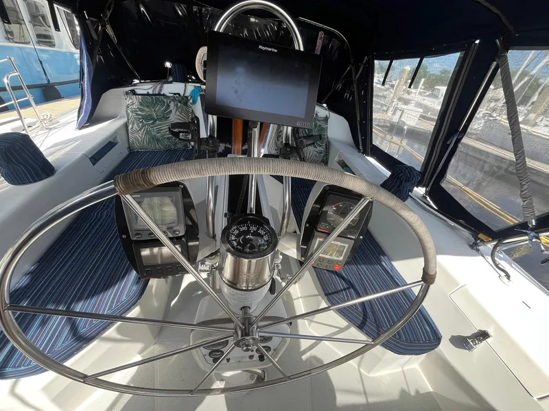 Slide: The Image of Cockpit of 1999 Catalina 42 MkII sailboat with steering wheel and navigation instruments. - 14