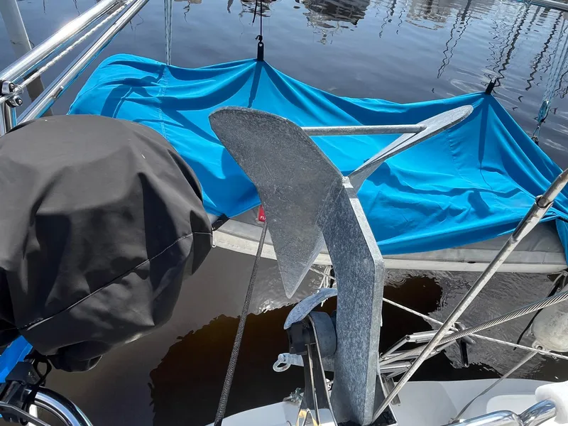 Slide: The Image of Sailboat anchor and blue tarp on 1999 Catalina 42 MkII at marina. - 21