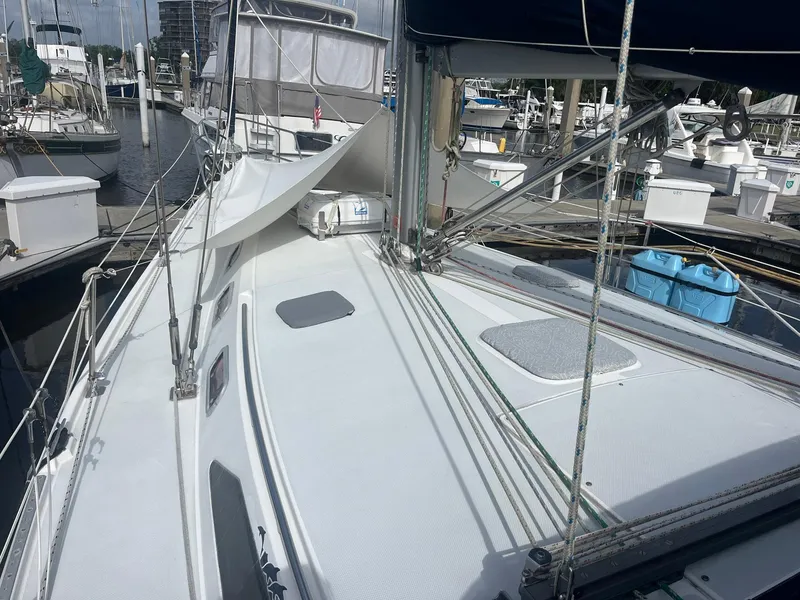 Slide: The Image of 1999 Catalina 42 MkII sailboat docked at marina, showing deck and rigging. - 29