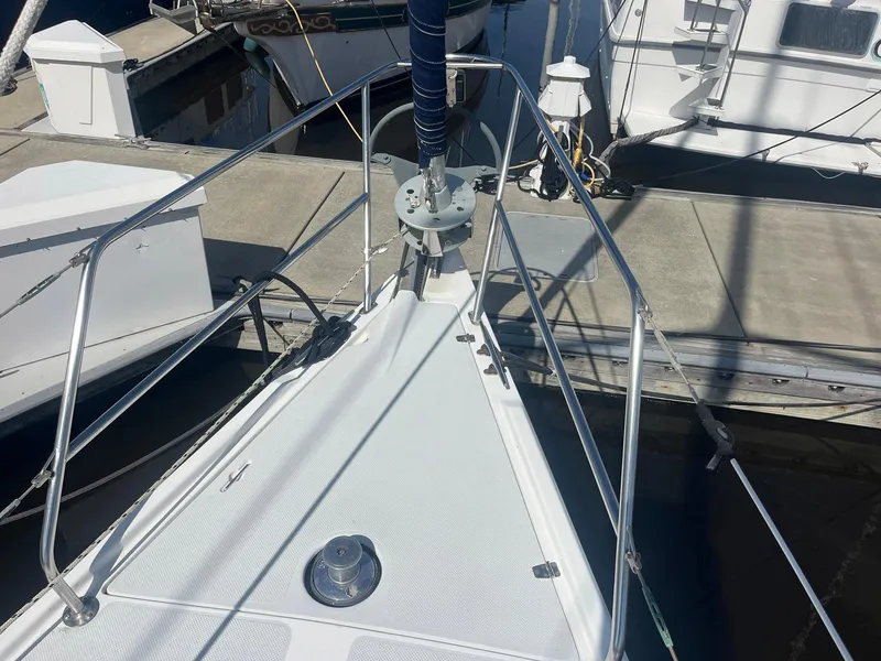Slide: The Image of Bow of a 1999 Catalina 42 MkII sailboat docked at a marina. - 33