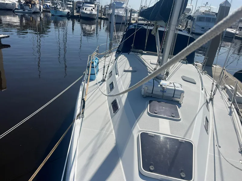 Slide: The Image of 1999 Catalina 42 MkII sailboat docked at marina, showing deck and rigging. - 37