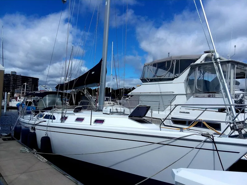 Slide: The Image of 1999 Catalina 42 MkII sailboat docked at marina under blue sky. - 4
