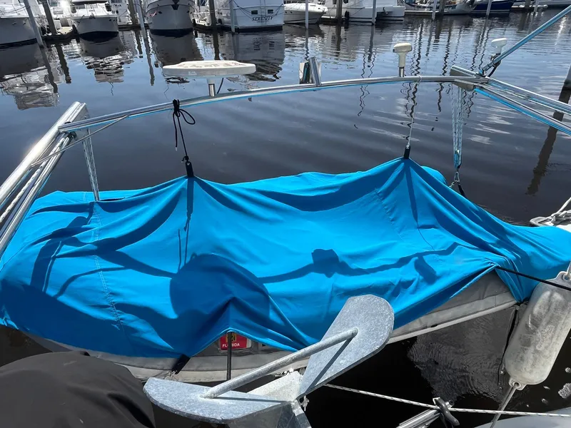 Slide: The Image of Blue tarp covering a section of a 1999 Catalina 42 MkII sailboat at a marina. - 41