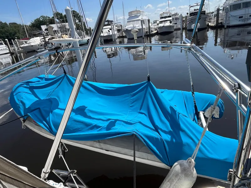 Slide: The Image of Sailboat with blue cover docked at marina, Catalina 42 MkII, 1999 model. - 43