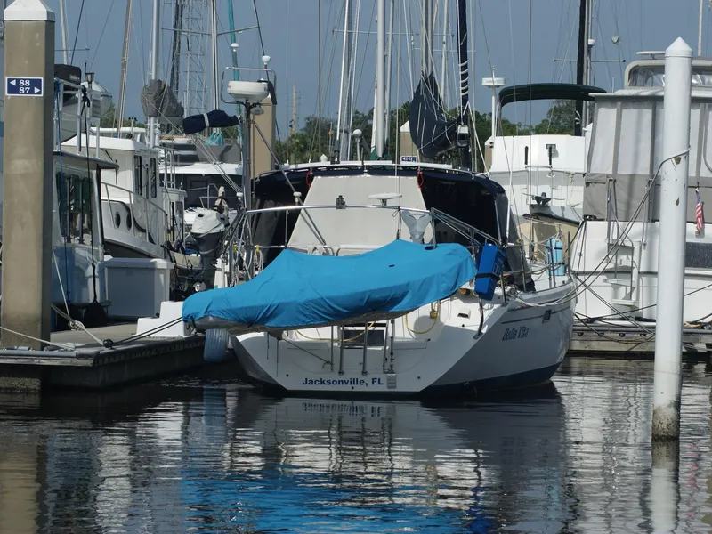 Slide: The Image of Catalina 42 MkII sailboat docked in Jacksonville marina, covered with a blue tarp. - 7