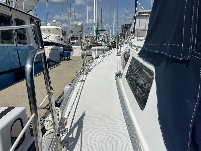 Slide: The Image of 1999 Catalina 42 MkII sailboat docked at marina under clear skies. - 8
