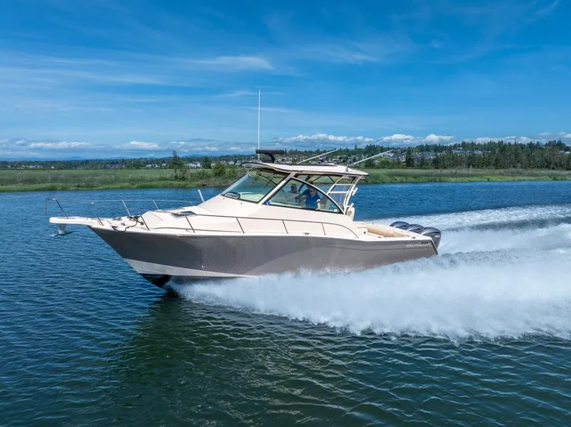 Slide: The Image of 2019 Grady-White Express boat cruising on a clear blue lake. - 0