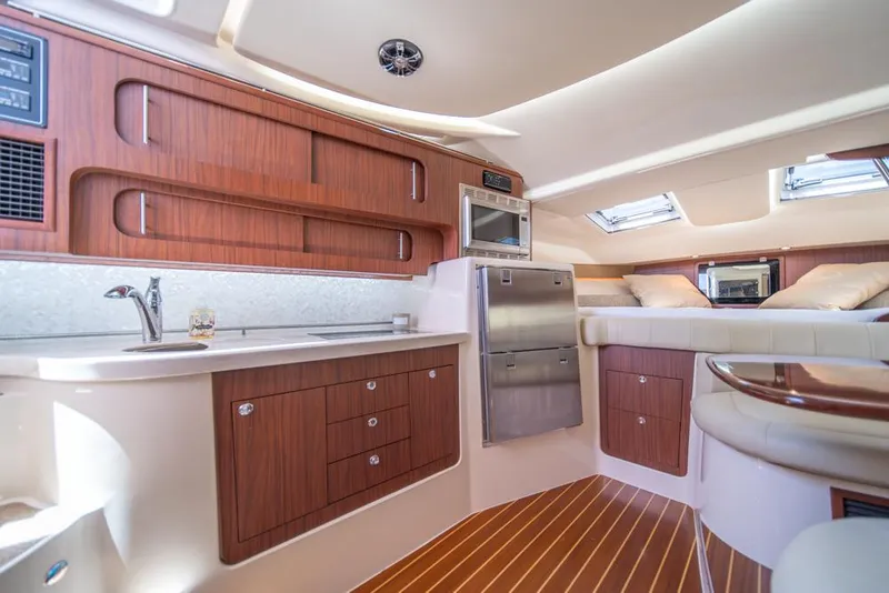 Slide: The Image of Luxurious 2019 Grady-White Express yacht interior with modern kitchen and cozy sleeping area. - 16