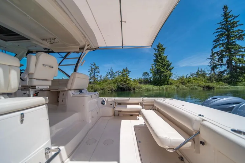 Slide: The Image of 2019 Grady-White Express boat interior with seating, canopy, and scenic water view. - 30