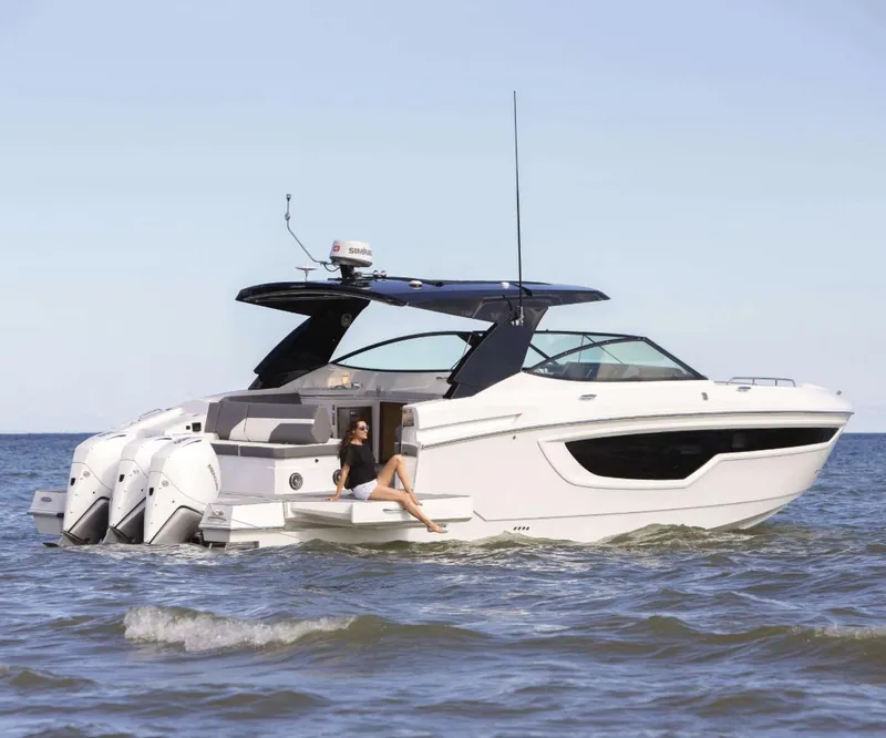 The Image of 2020 Cruisers Yachts 38 GLS in water, featuring sleek design and triple outboard engines. - 0