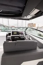 Slide: The Image of 2020 Cruisers Yachts 38 GLS helm with modern controls and marina view. - 11