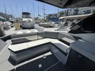 Slide: The Image of 2020 Cruisers Yachts 38 GLS with sleek seating, docked in a marina. - 18
