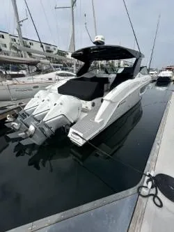 Slide: The Image of 2020 Cruisers Yachts 38 GLS docked, showcasing sleek design and powerful engines. - 6