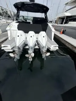 Slide: The Image of 2020 Cruisers Yachts 38 GLS with triple outboard engines docked at marina. - 8