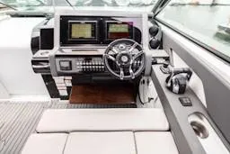 Slide: The Image of 2020 Cruisers Yachts 38 GLS helm with modern controls and navigation screens. - 12