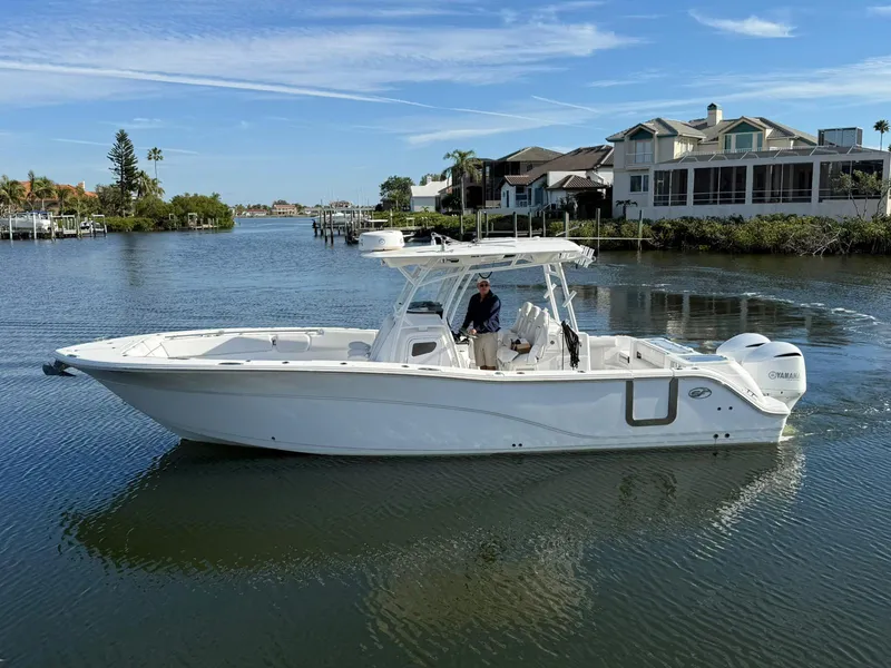 The Image of 2021 Sea Fox 328 Commander boat cruising on a calm waterway near waterfront homes. - 0