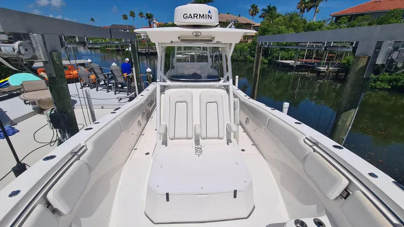Slide: The Image of 2021 Sea Fox 328 Commander boat docked, featuring spacious seating and Garmin navigation. - 10