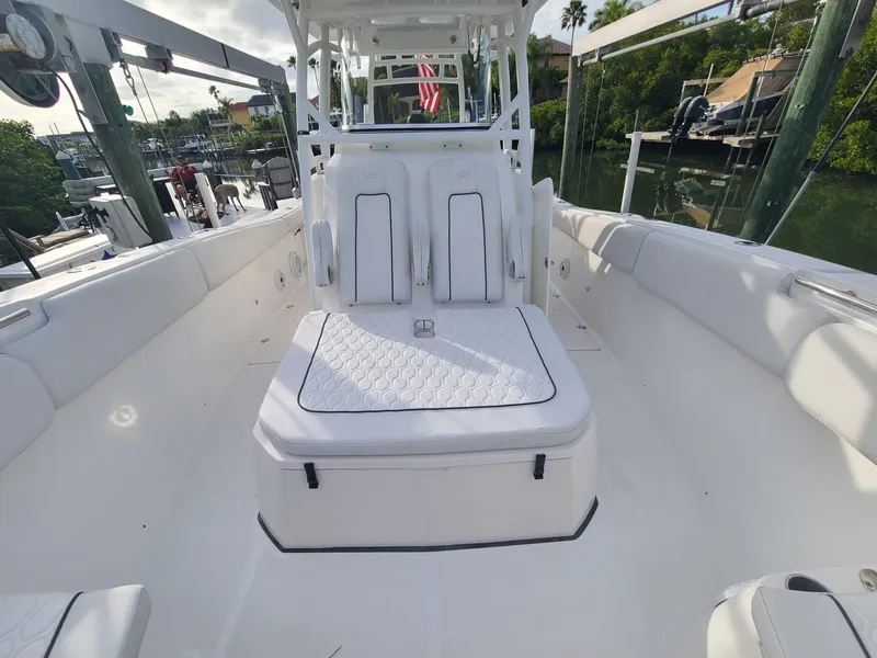 Slide: The Image of 2021 Sea Fox 328 Commander boat interior with white seating and sleek design. - 11