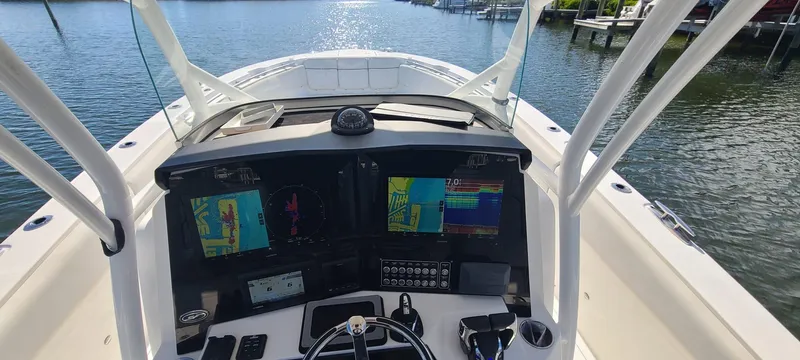 Slide: The Image of Helm of 2021 Sea Fox 328 Commander with advanced navigation displays on a sunny day. - 15