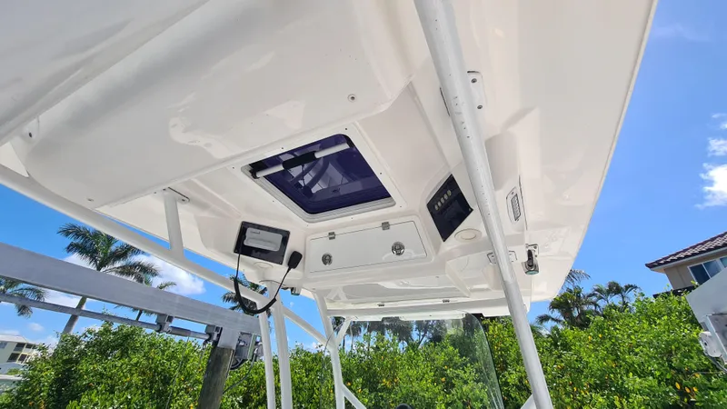 Slide: The Image of 2021 Sea Fox 328 Commander boat roof with electronics, under clear blue sky. - 17