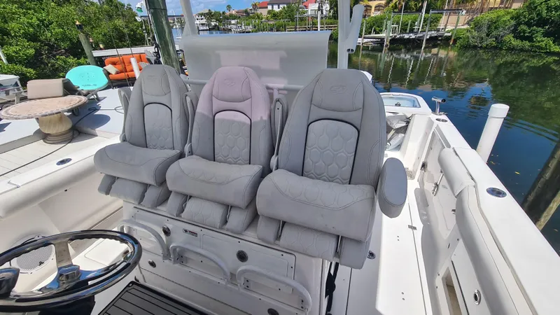 Slide: The Image of 2021 Sea Fox 328 Commander boat interior with three cushioned seats and steering wheel. - 20