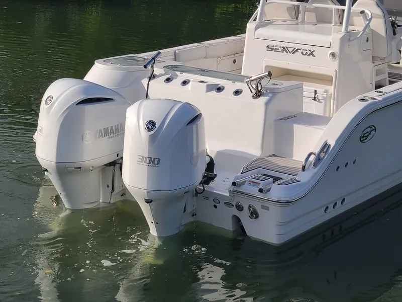 Slide: The Image of 2021 Sea Fox 328 Commander with twin Yamaha 300 engines on calm water. - 29