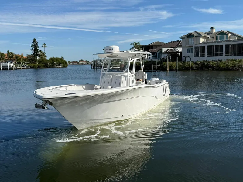 Slide: The Image of 2021 Sea Fox 328 Commander boat cruising on a calm waterway near waterfront homes. - 3