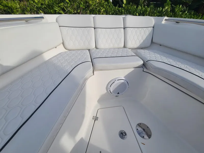 Slide: The Image of 2021 Sea Fox 328 Commander boat interior with white cushioned seating. - 8