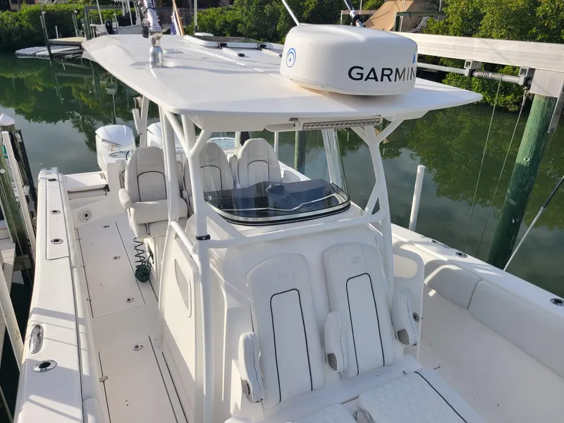 Slide: The Image of 2021 Sea Fox 328 Commander boat with Garmin equipment, docked in a serene marina. - 9
