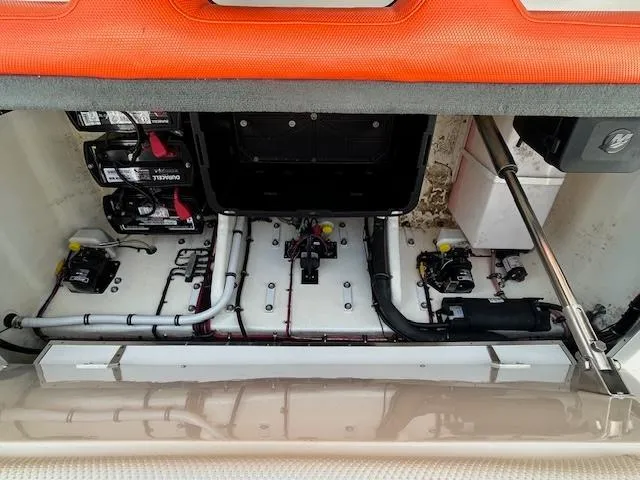 Slide: The Image of Engine compartment of a 2021 Velocity 290 SC boat, showcasing batteries and wiring. - 11