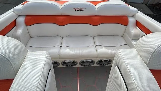 Slide: The Image of 2021 Velocity 290 SC boat interior with white and orange seating and built-in speakers. - 12