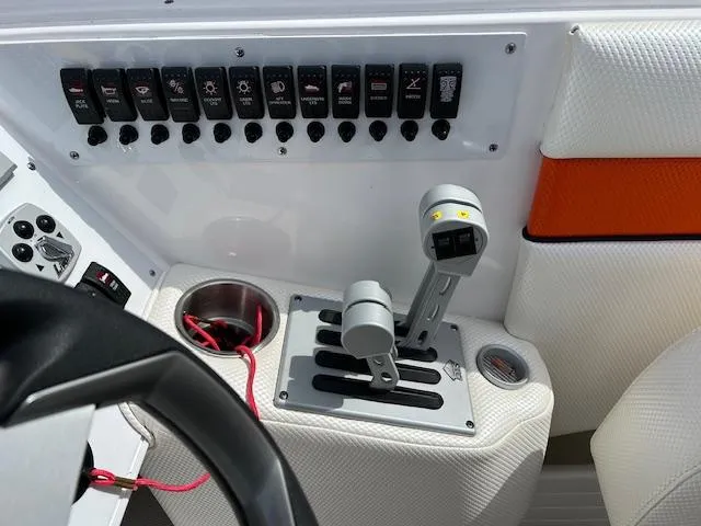 Slide: The Image of Control panel of a 2021 Velocity 290 SC boat with switches and throttle levers. - 15