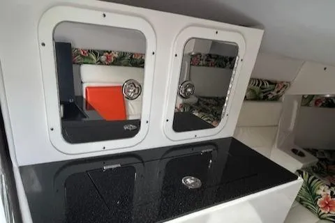 Slide: The Image of 2021 Velocity 290 SC interior with floral upholstery and sleek cabinetry design. - 20