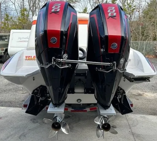 Slide: The Image of 2021 Velocity 290 SC boat with dual outboard engines, parked outdoors. - 7