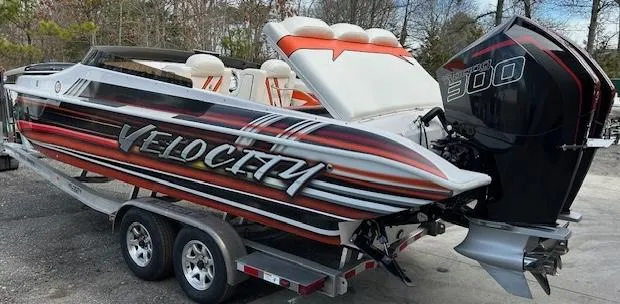 Slide: The Image of 2021 Velocity 290 SC speedboat on trailer with powerful outboard motor. - 9