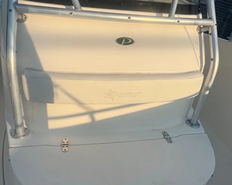 Slide: The Image of 2001 Pursuit 3070 Center Console boat interior with logo and seating area. - 10