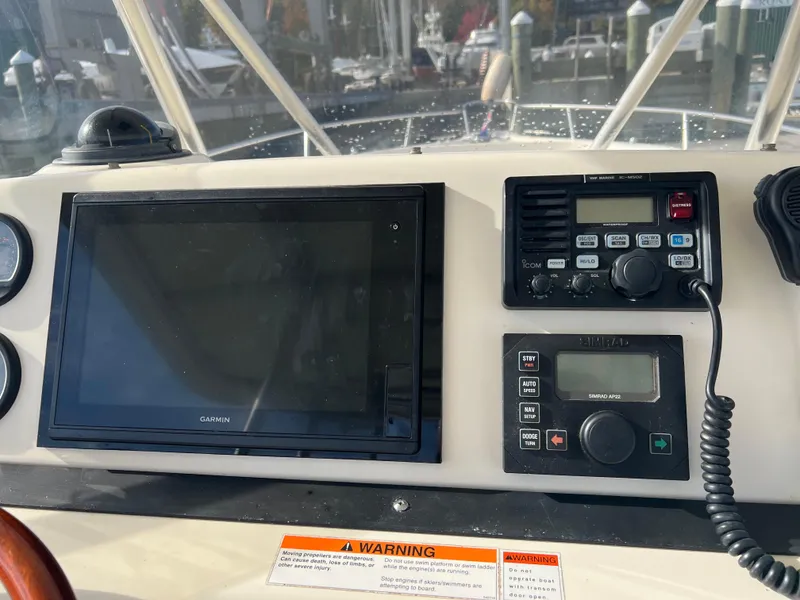 Slide: The Image of Control panel of a 2001 Pursuit 3070 Center Console boat with Garmin and Icom devices. - 13