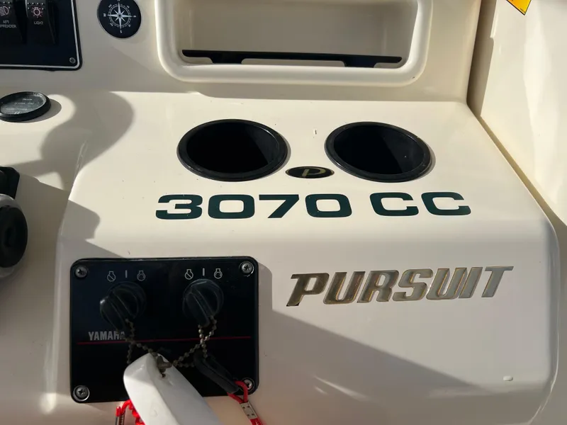 Slide: The Image of 2001 Pursuit 3070 Center Console boat dashboard with Yamaha controls. - 16