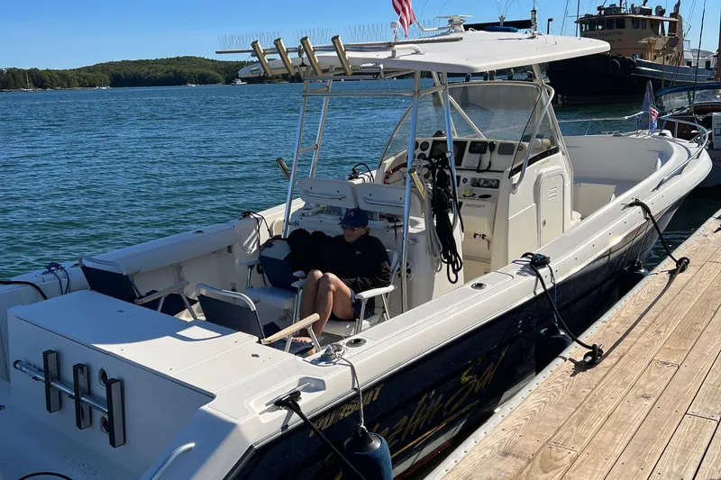 Slide: The Image of 2001 Pursuit 3070 Center Console boat docked by the water. - 22