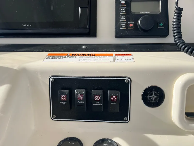 Slide: The Image of Control panel of a 2001 Pursuit 3070 Center Console boat with switches and navigation equipment. - 23