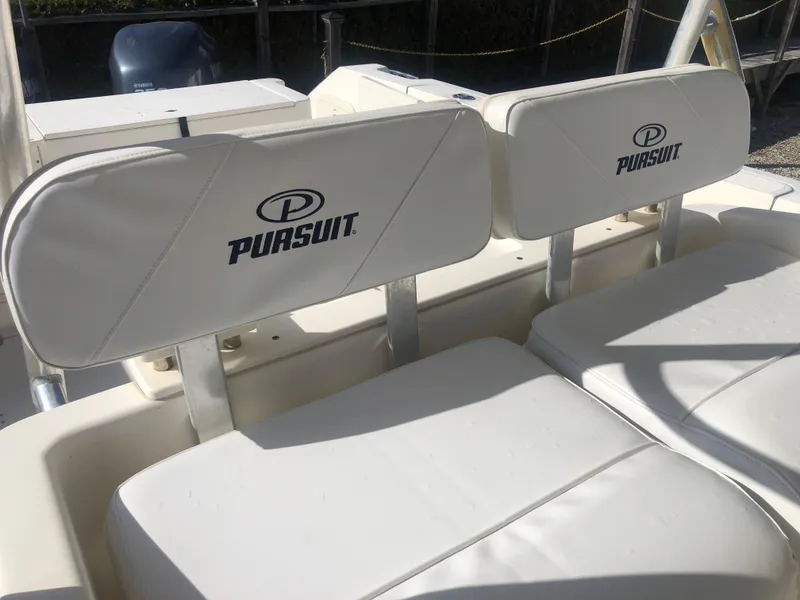 Slide: The Image of 2001 Pursuit 3070 Center Console boat seats with logo, white upholstery. - 27