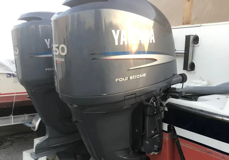 Slide: The Image of Twin Yamaha 150 four-stroke outboard motors on a 2001 Pursuit 3070 Center Console boat. - 31