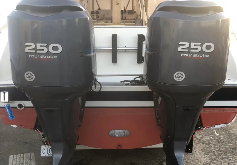 Slide: The Image of Twin 250 horsepower four-stroke engines on a 2001 Pursuit 3070 Center Console boat. - 32