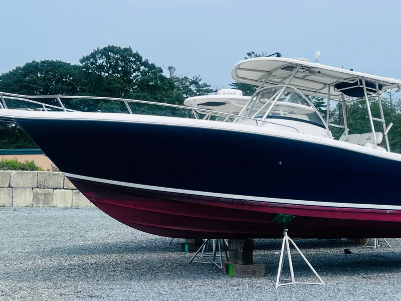 Slide: The Image of 2001 Pursuit 3070 Center Console boat on display in a marina setting. - 36