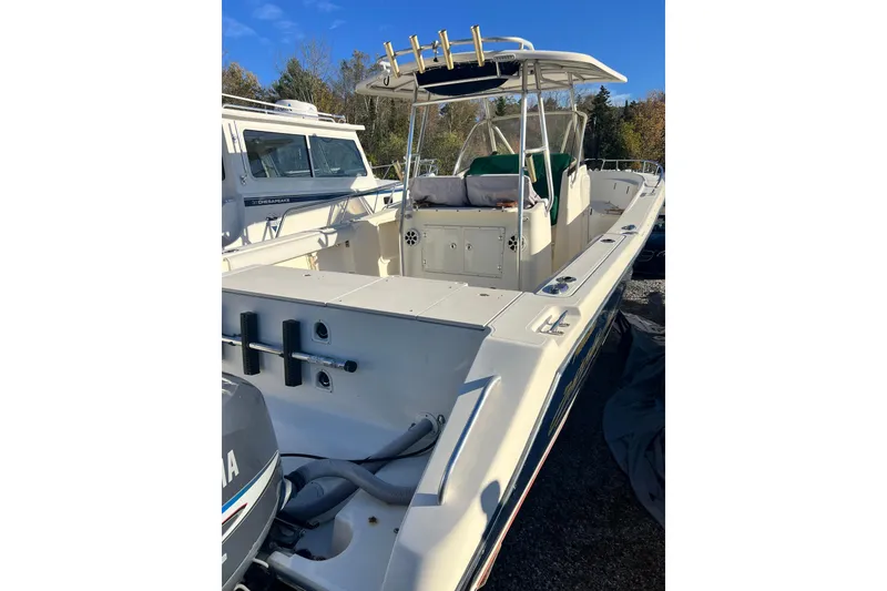 Slide: The Image of 2001 Pursuit 3070 Center Console boat with spacious deck and fishing rod holders. - 45