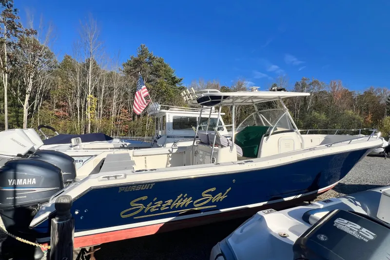 Slide: The Image of 2001 Pursuit 3070 Center Console boat with Yamaha engines, docked outdoors. - 47