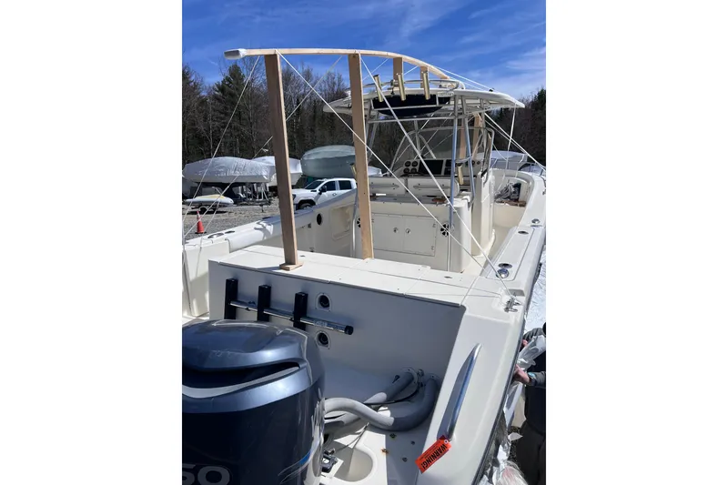 Slide: The Image of 2001 Pursuit 3070 Center Console boat with outboard motor, docked outdoors. - 54